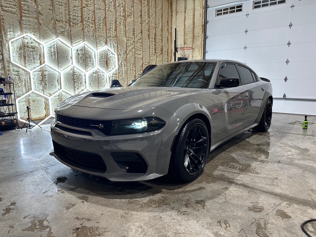 Gray performance car with dark wheels and tinted windows