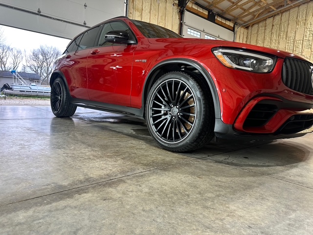 Low angle red Mercedes SUV with black wheels